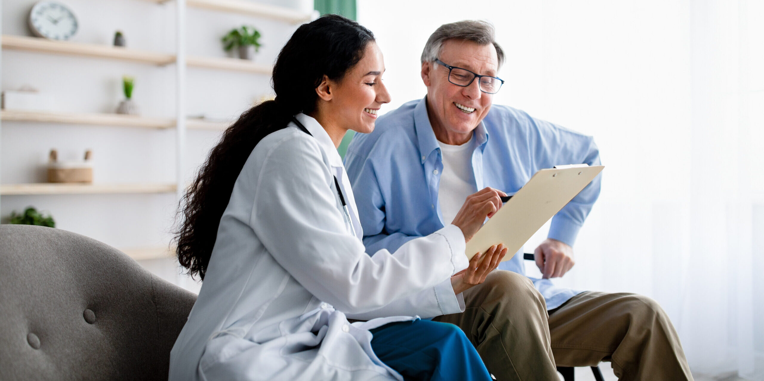 Primary care physician meeting with an older adult and caregiver in Greater Phoenix, Arizona.