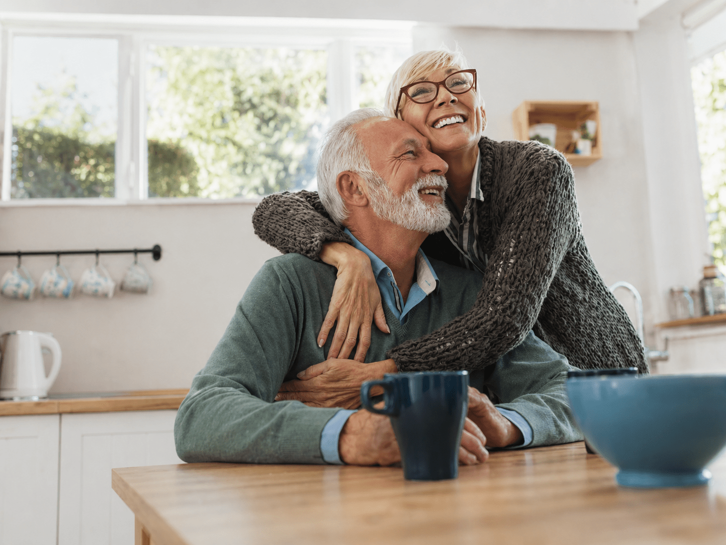 Senior couple at home receiving healthcare support and guidance.